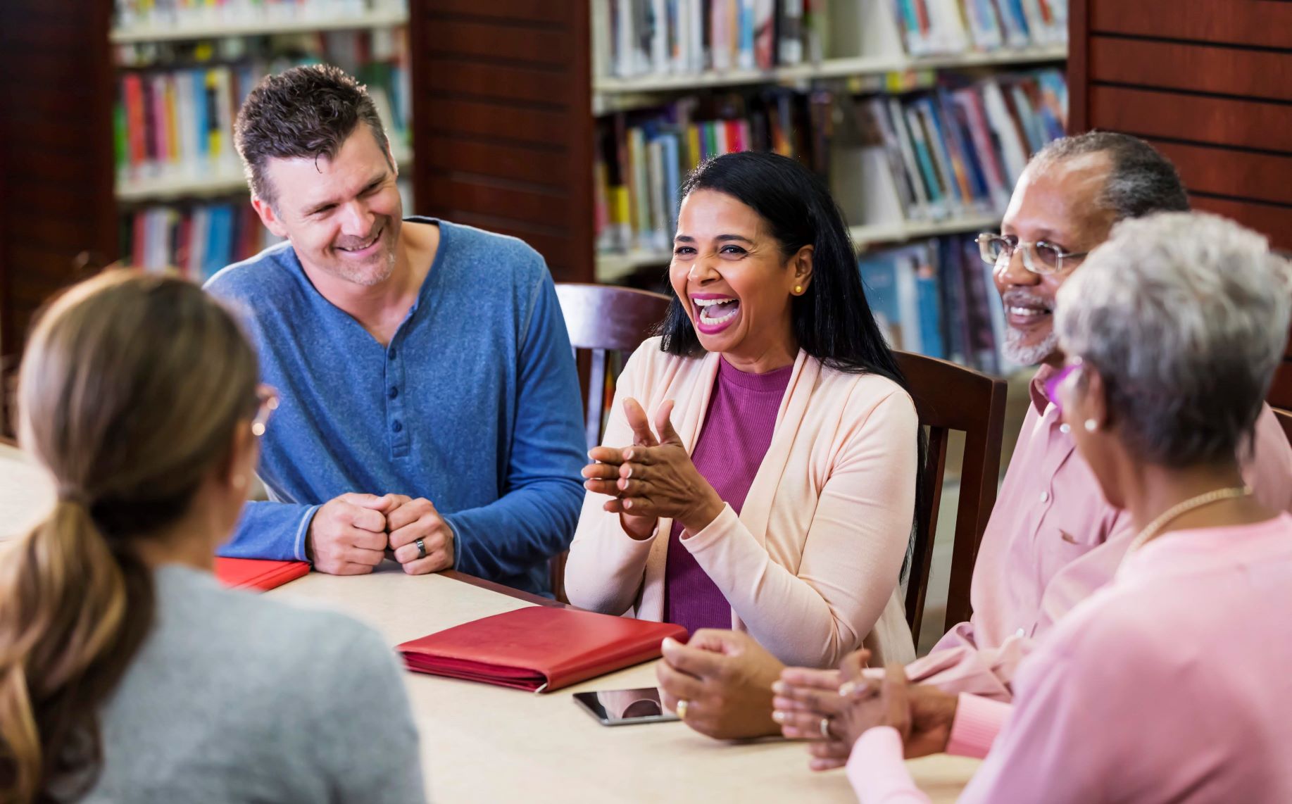 A group of professionals meeting in the library