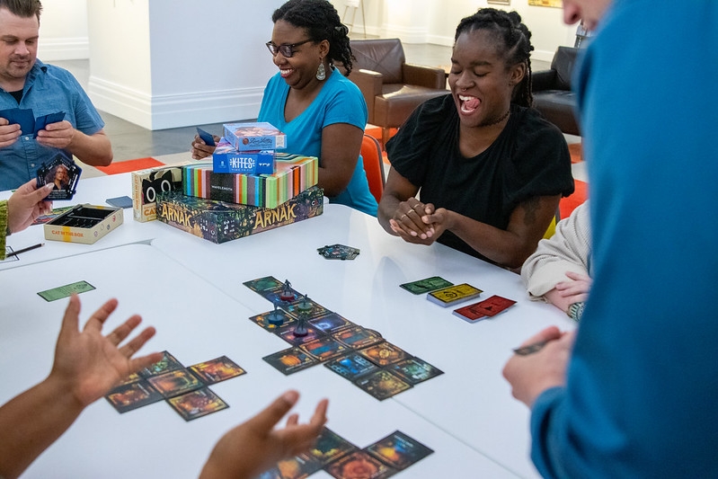 Adults playing a tabletop board game