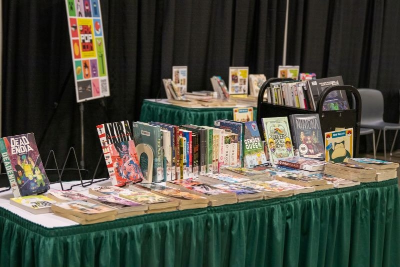 Table filled with library books and manga